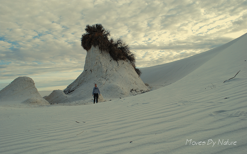 A person standing in front of the tallest pedestal of White Sands