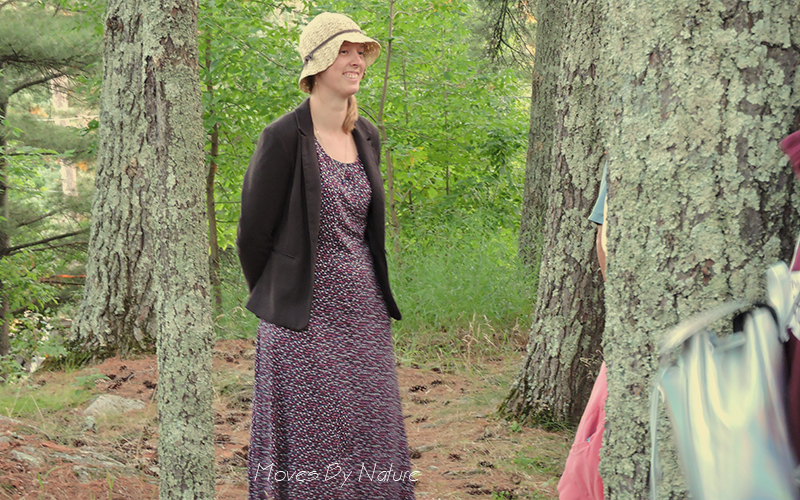 Woman in forest wearing a hat and dress