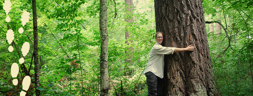 woman hugging a tree in a forest